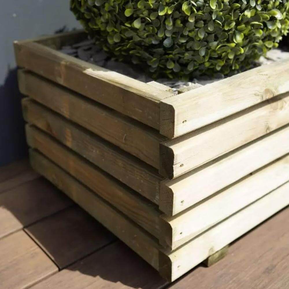 large wooden cube planter with plant in