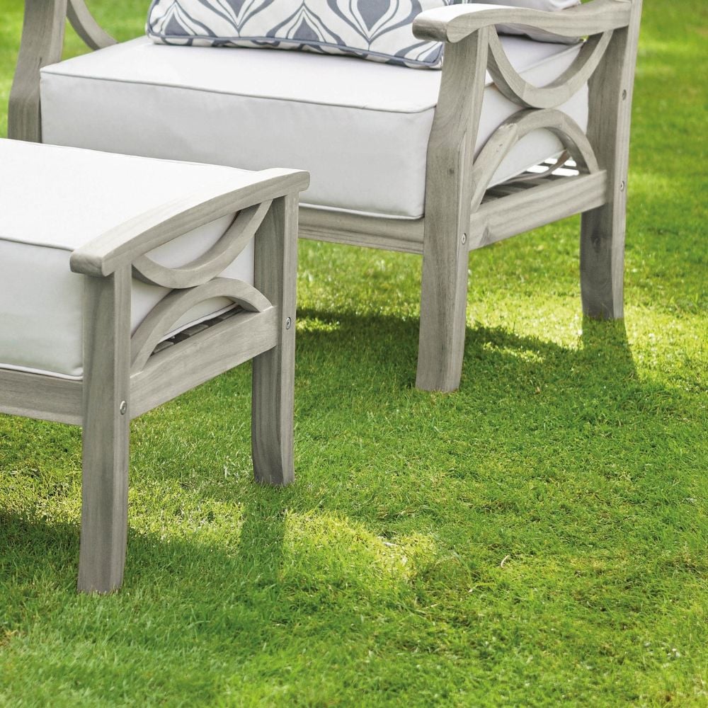 grey washed garden chair and footstall on grass