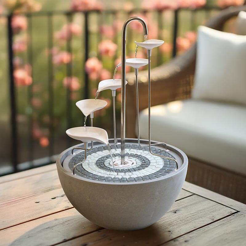 Small outdoor fountain with water feature on a wooden deck