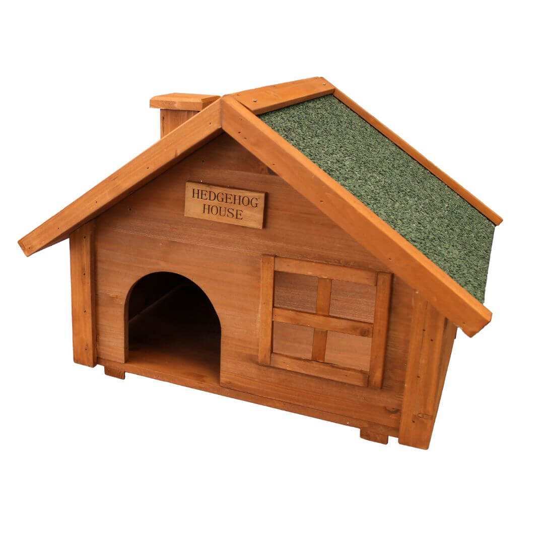 Wooden hedgehog house with a green roof on a white background