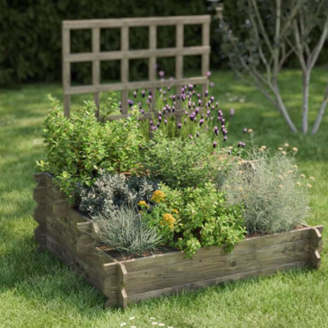 Wooden raised garden bed with plants and flowers on a grassy area