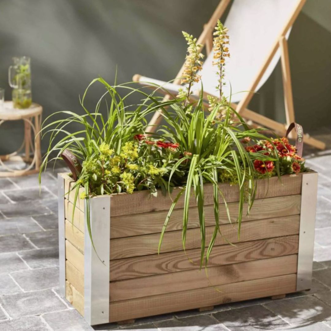 Wooden planter box with plants on a patio