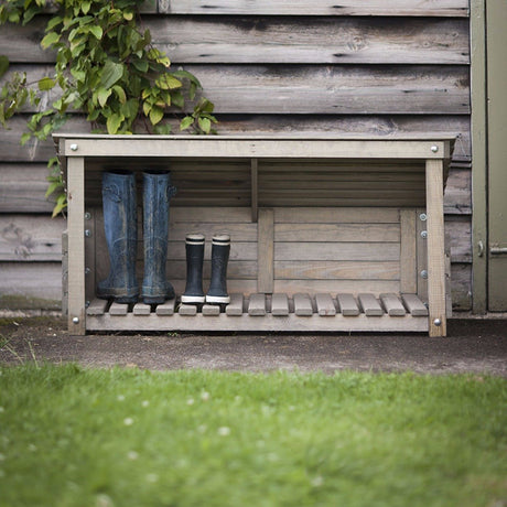 Wooden wellie store in garden with boots in it