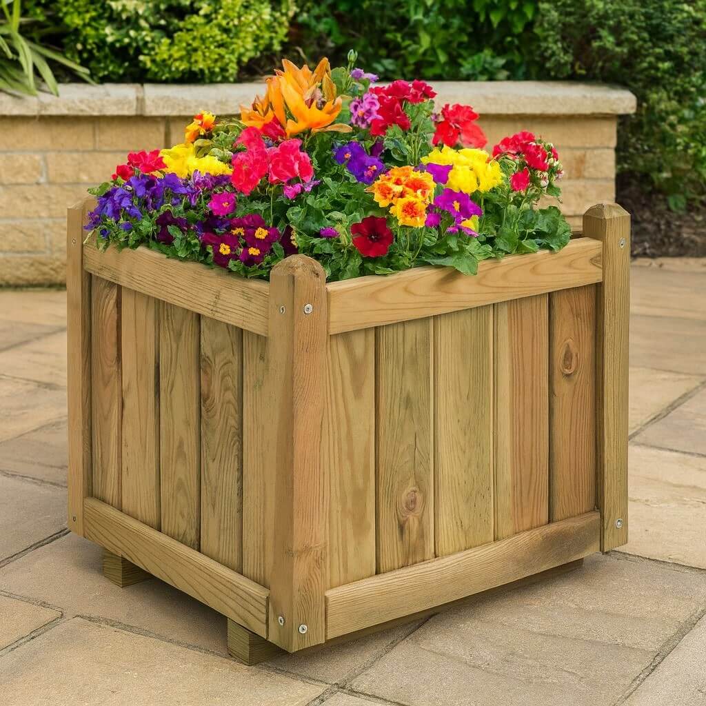 Wooden planter box with colorful flowers on a patio
