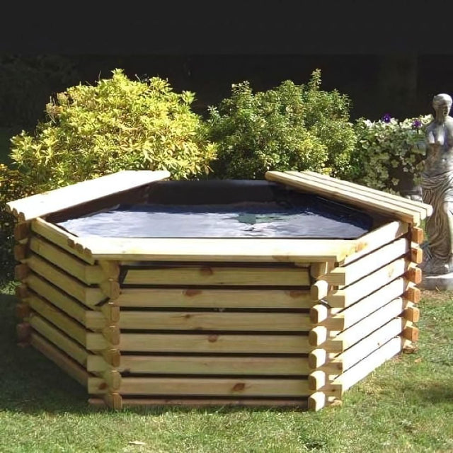 wooden pond in garden sat on grass with bushes in the background