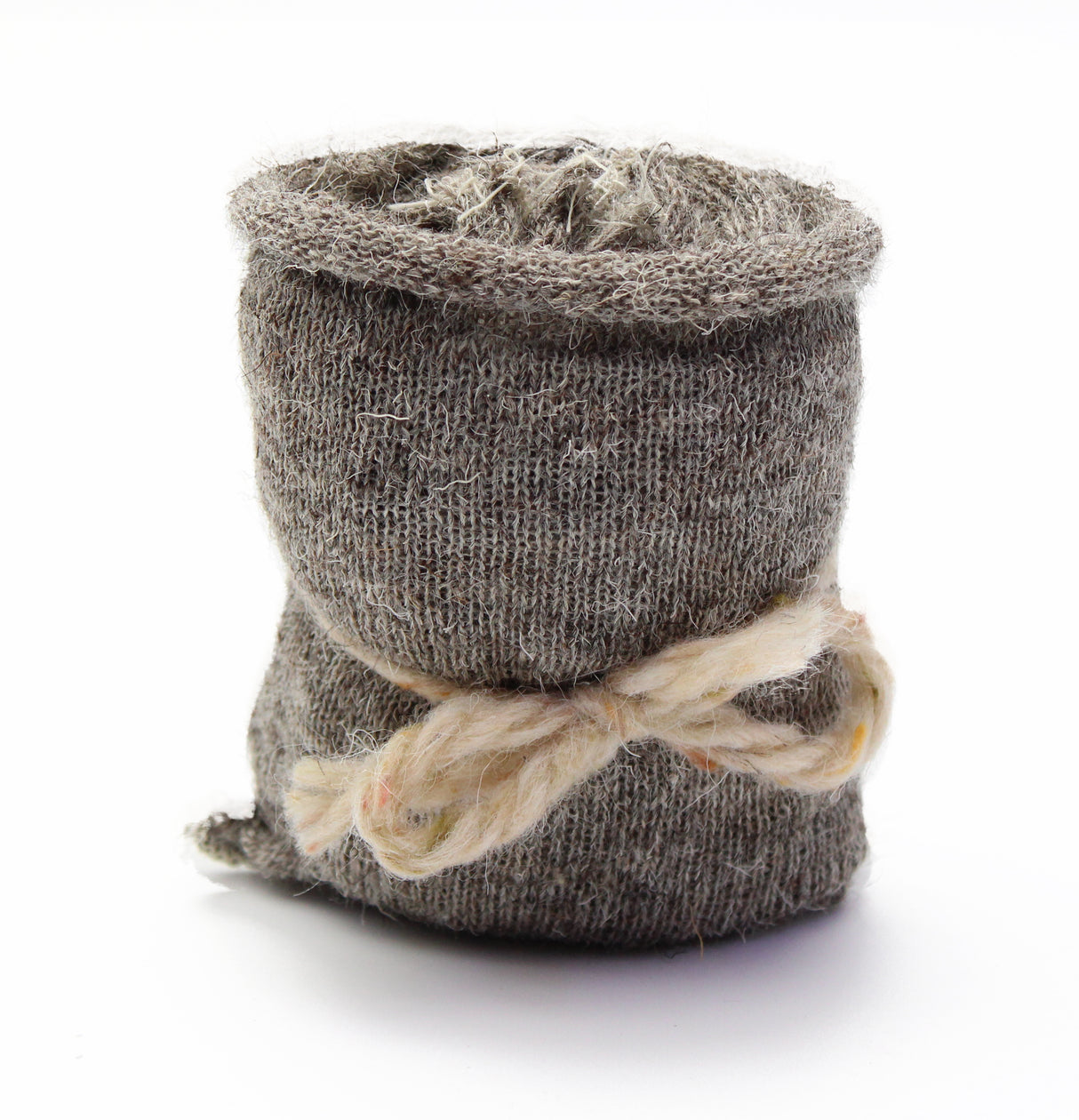 Textured brown pot wrapped in twine on a white background
