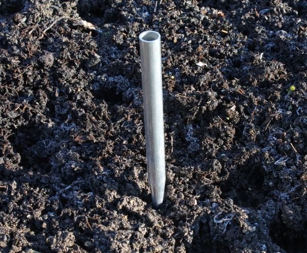 Aluminium anchor tube with a pointed end pushed into the soil