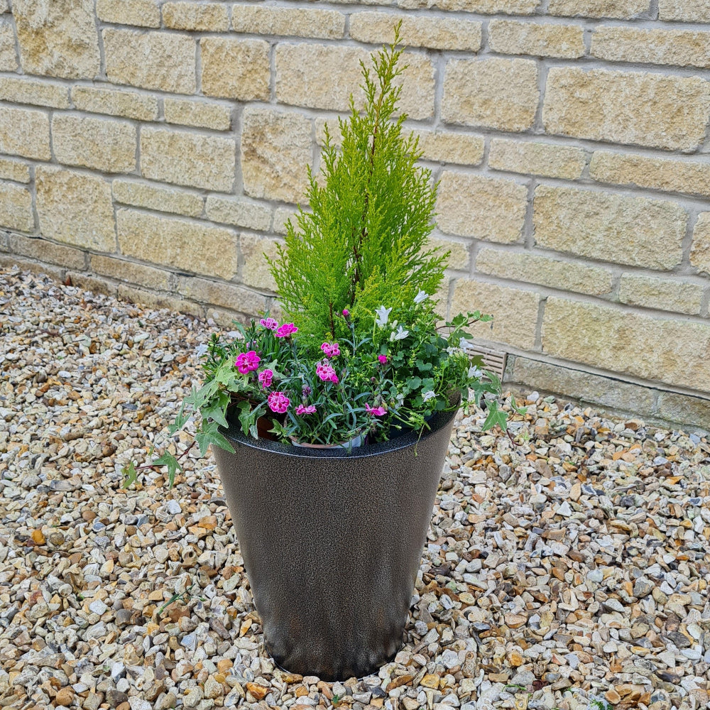 black aluzinc cone planter in garden