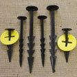 A set of black barbed pegs with washers