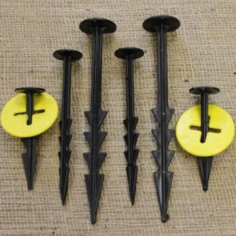 A set of black barbed pegs with washers
