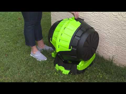 barrel composter with someone opening in garden