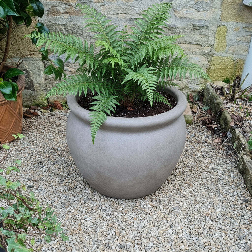 weathered terracotta planter in garden
