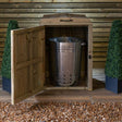 single bin storage cupboard holding silver dustbin on decking
