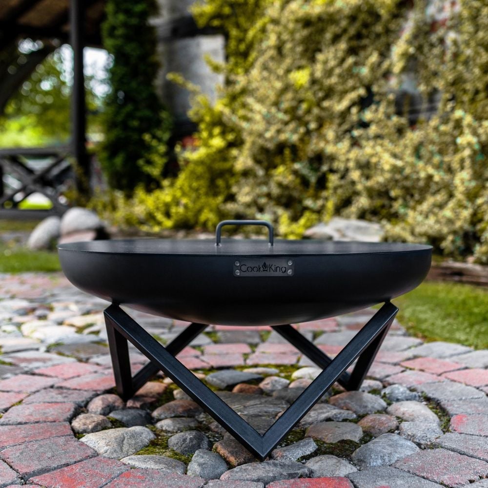 black bowl firepit style grill with metal cover with triangular legs