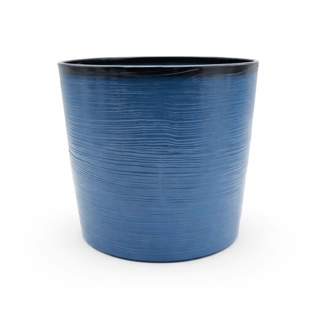 Blue planter with black interior on a white background