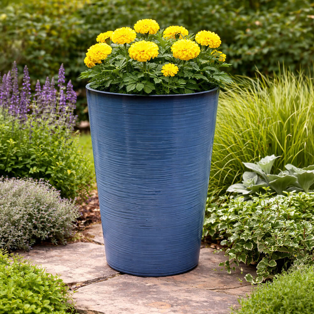Blue planter with yellow flowers in a garden setting