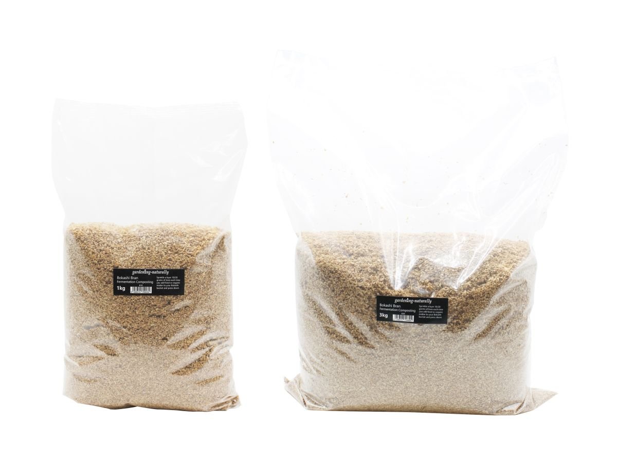 Two transparent plastic bags, one labeled as 1kg and the other as 2kg, containing Bokashi Bran for composting.