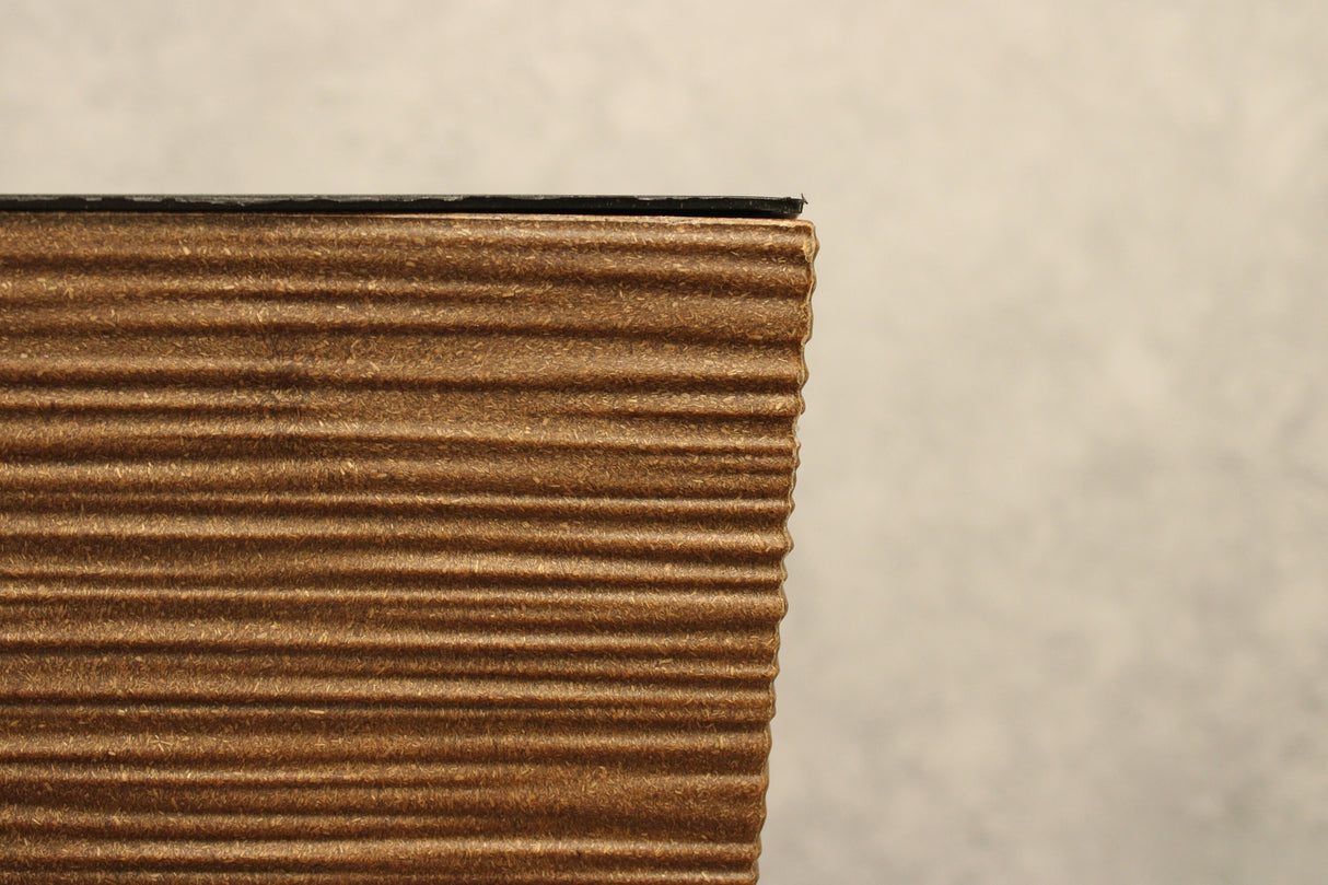 Close-up of the textured ribbed finish on a brown square plant pot