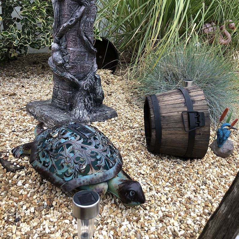 Burnt wooden garden half barrel decoration with turtle