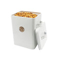 A French Grey metal cat food tin with a rose gold tag, lid off, filled with cat biscuits.