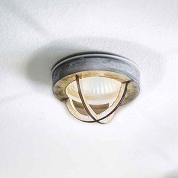 A recessed industrial style ceiling light with a cast zinc fixture and a downlight bulb.