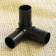 A black corner joiner for fruit and vegetable cages made of 19mm aluminium poles and hoops.