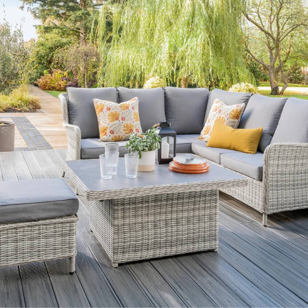 Garden furniture on decking in garden with cushions