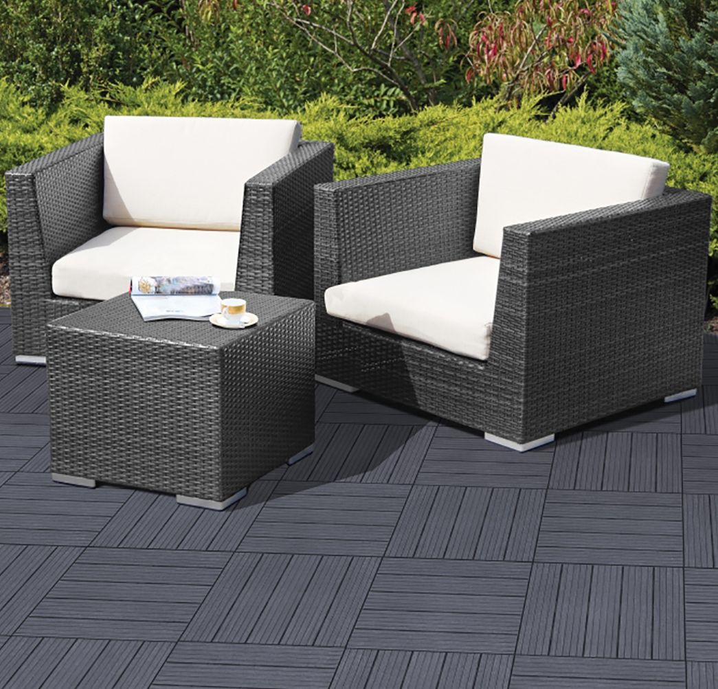 Decking tiles forming patio with 2 chairs and coffee table in garden