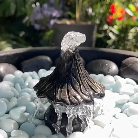 Decorative water feature with flowing water on pebbles