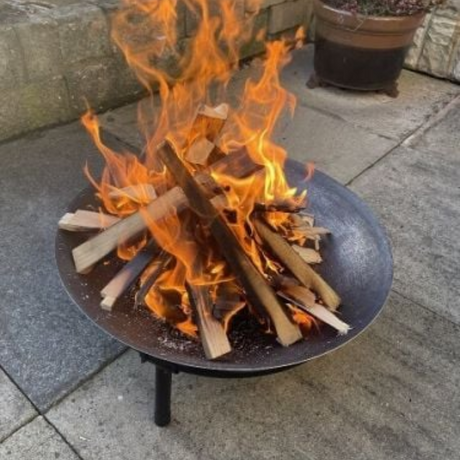 fire pit in use with fire on patio