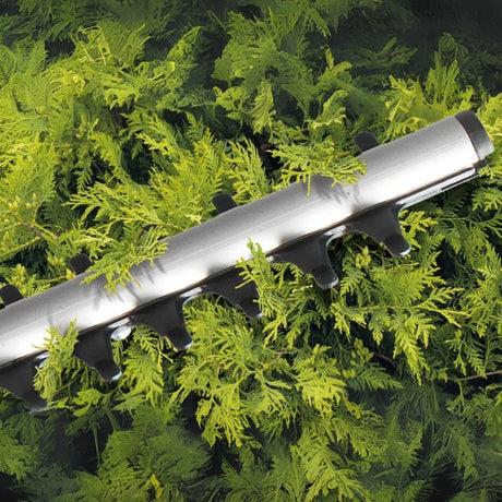 flymo hedge trimmer cutting a hedge