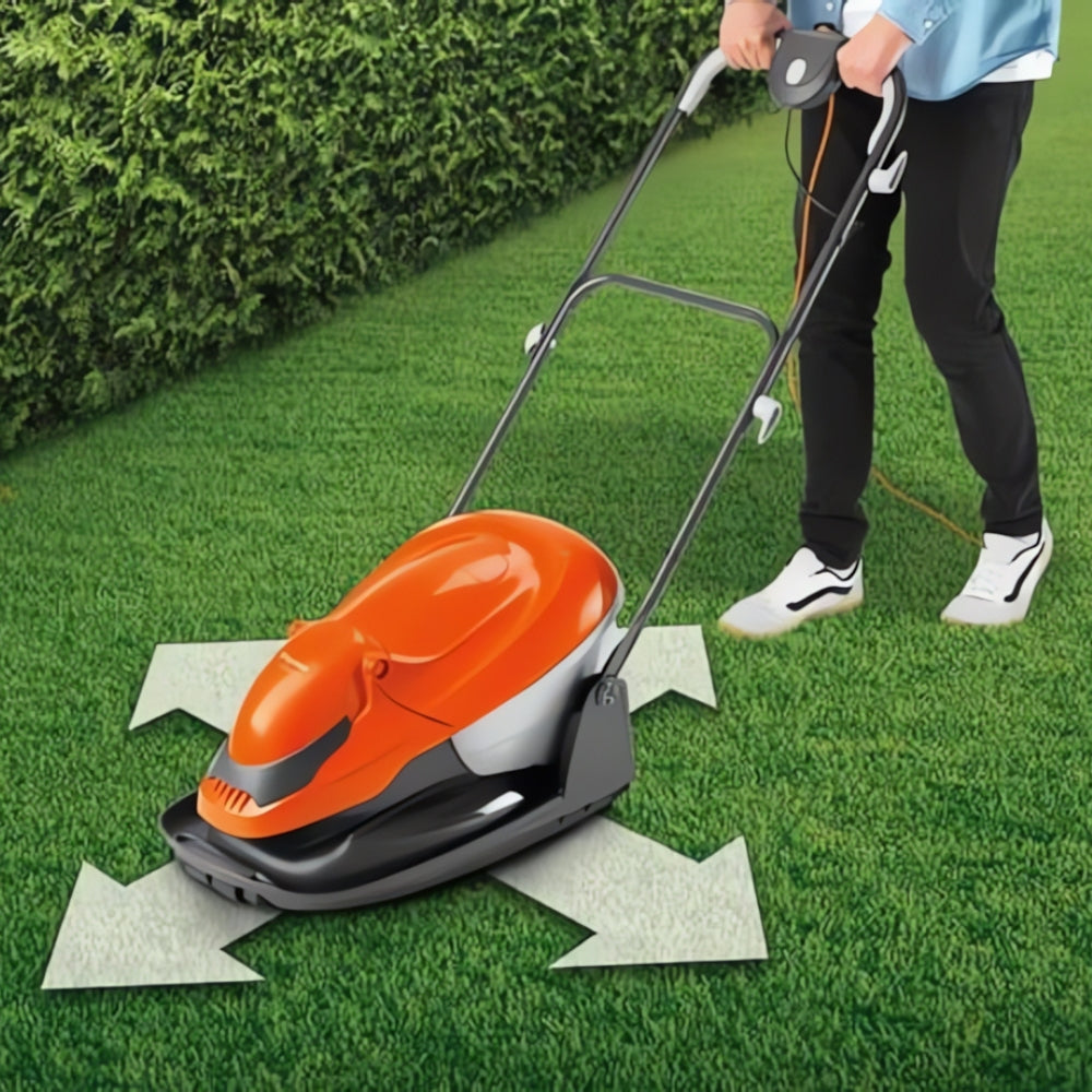 Lady pushing flymo lawnmower over lawn showing easy move in all directions