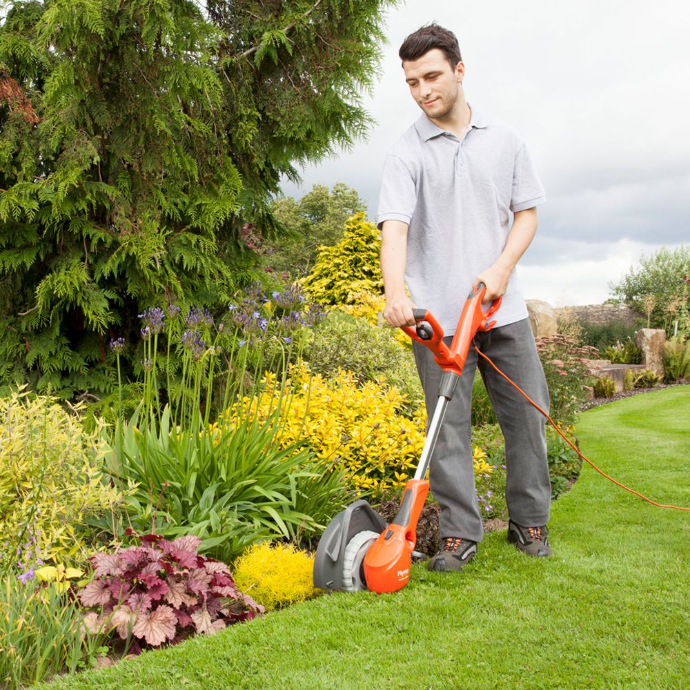 strimmer being used on grass garden borders