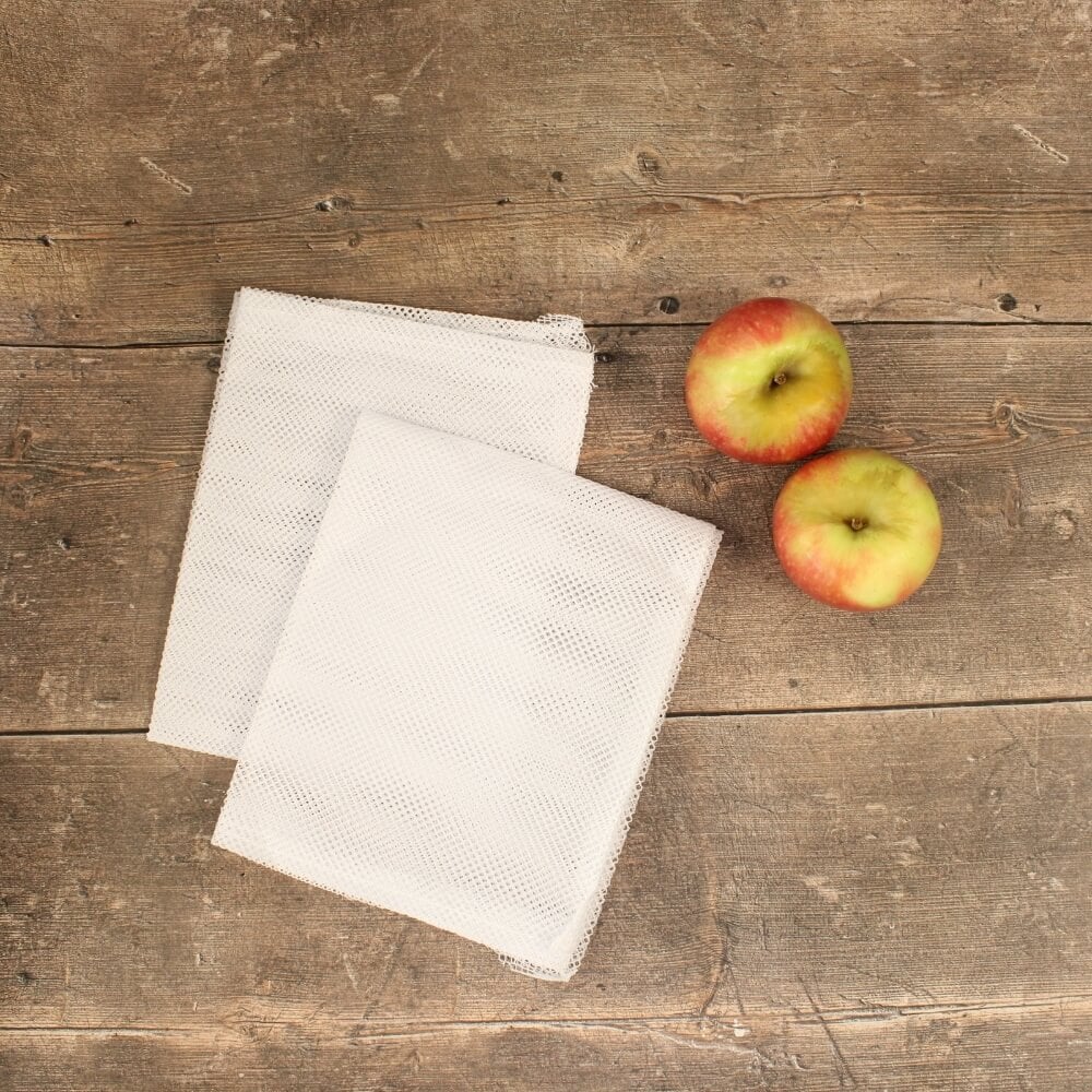 Apple and bags for fruit press on a table