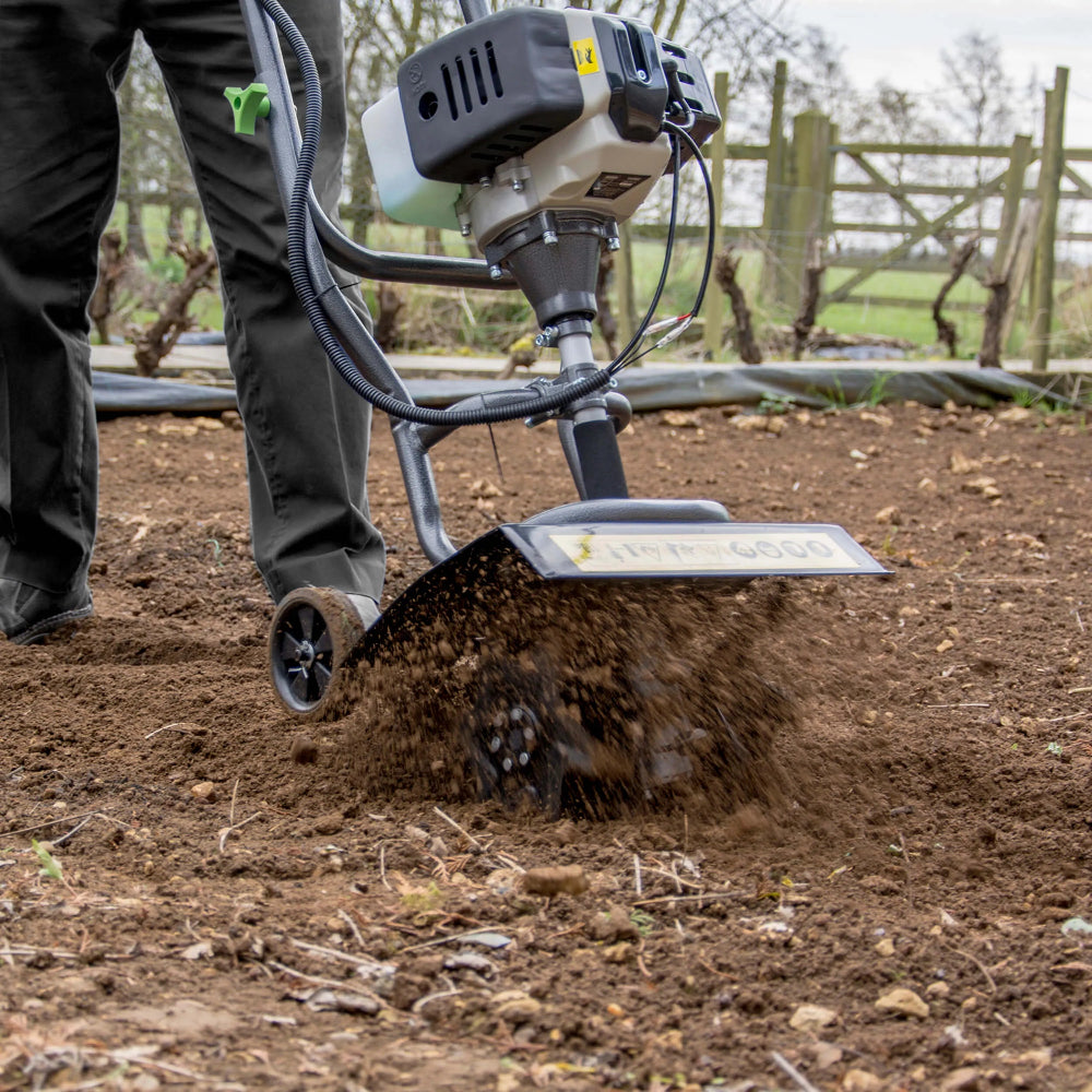 garden petrol tiller in use in garden