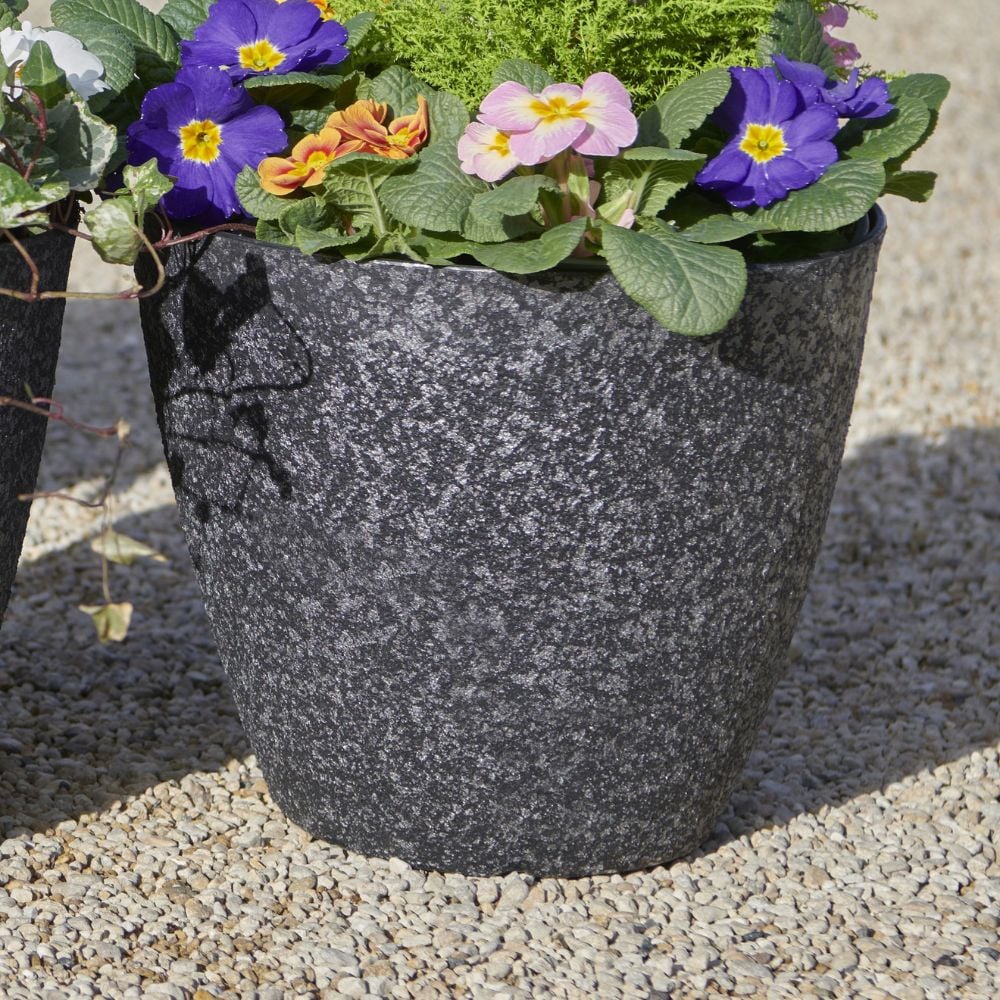 stone effect plant pot with granite effect and flowers