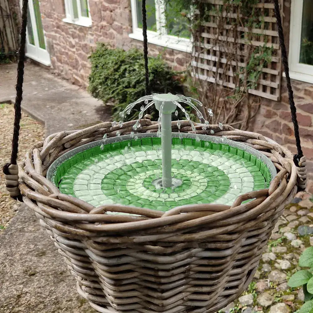 Decorative water fountain in a wicker basket