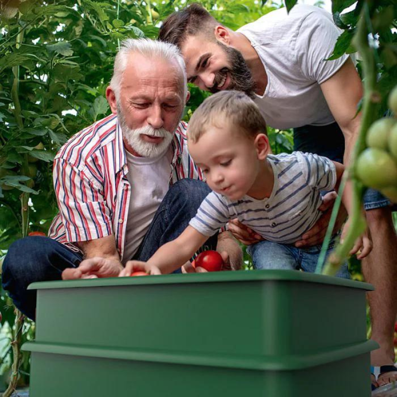 3 people adding things to the wormery including child
