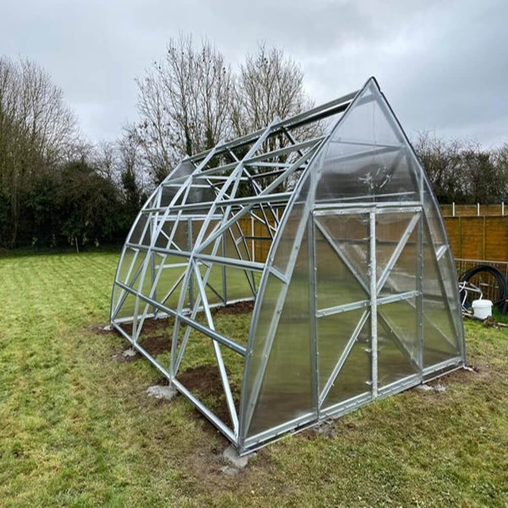 the frame of a greenhouse in a garden