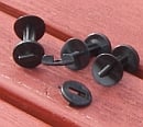 Two black greenhouse insulation/shading clips