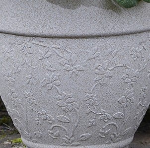 Design of grey garden pot stood in garden