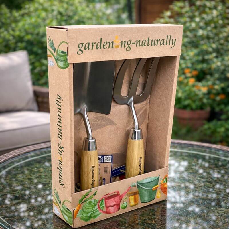 Gardening Naturally hand trowel and fork gift set angled view on outdoor table