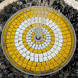 Mosaic design with yellow and white tiles on a circular pattern