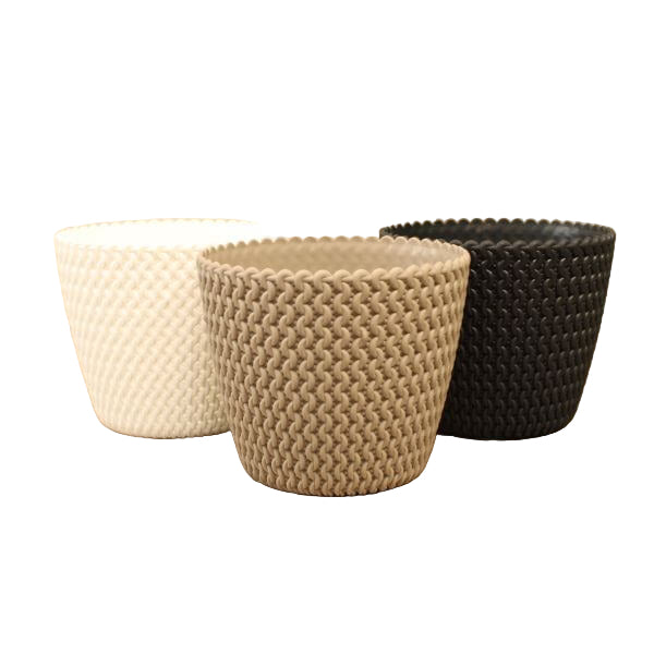 Three Abelia flowerpots in mocha, white, and anthracite colors, displayed on a wooden surface against a beige background.