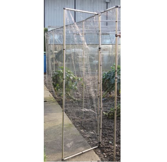 An additional door kit for a large cage, featuring an aluminum frame and mesh netting, shown in a garden setting.