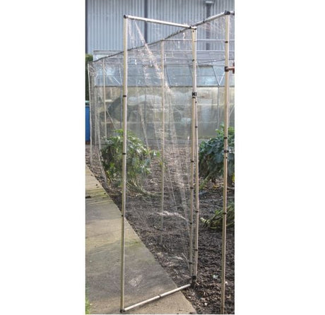 An additional door kit for a large cage, featuring an aluminum frame and mesh netting, shown in a garden setting.