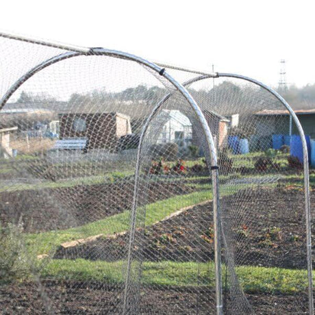 An empty aluminum hoop frame designed for use as a plant cage in a garden setting.