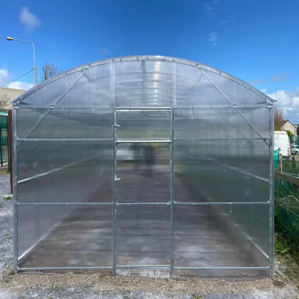 large greenhouse on gravel
