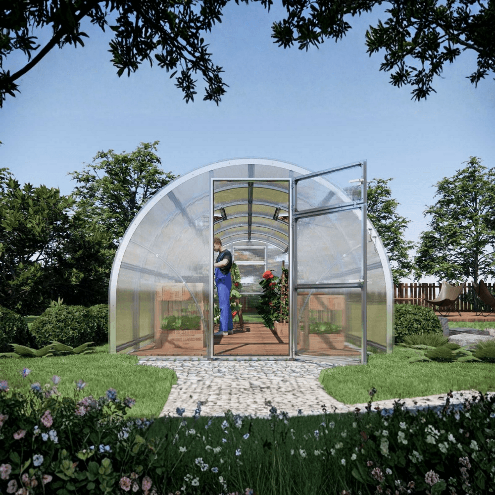Modern greenhouse with transparent walls and a curved roof in a garden setting.