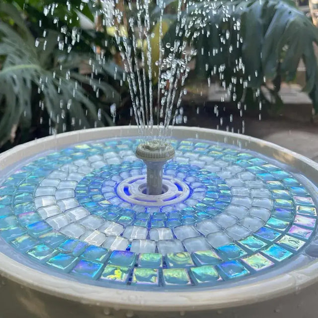 Mosaic water fountain surrounded by greenery
